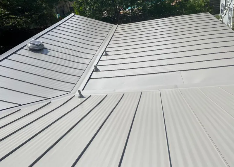 Solar attic fan installed on a metal roof for Roof Ventilation in Columbia City